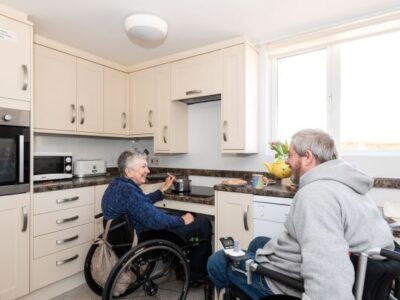 Kitchen with height adjustable hob and sink